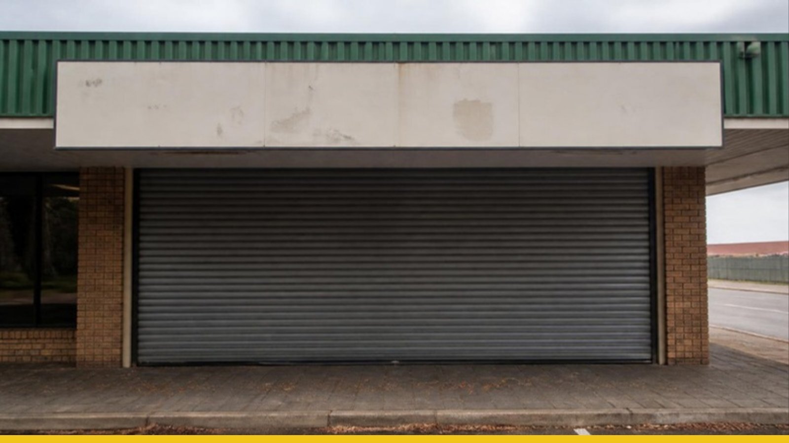 Closed-down shopfront with its roller door pulled down