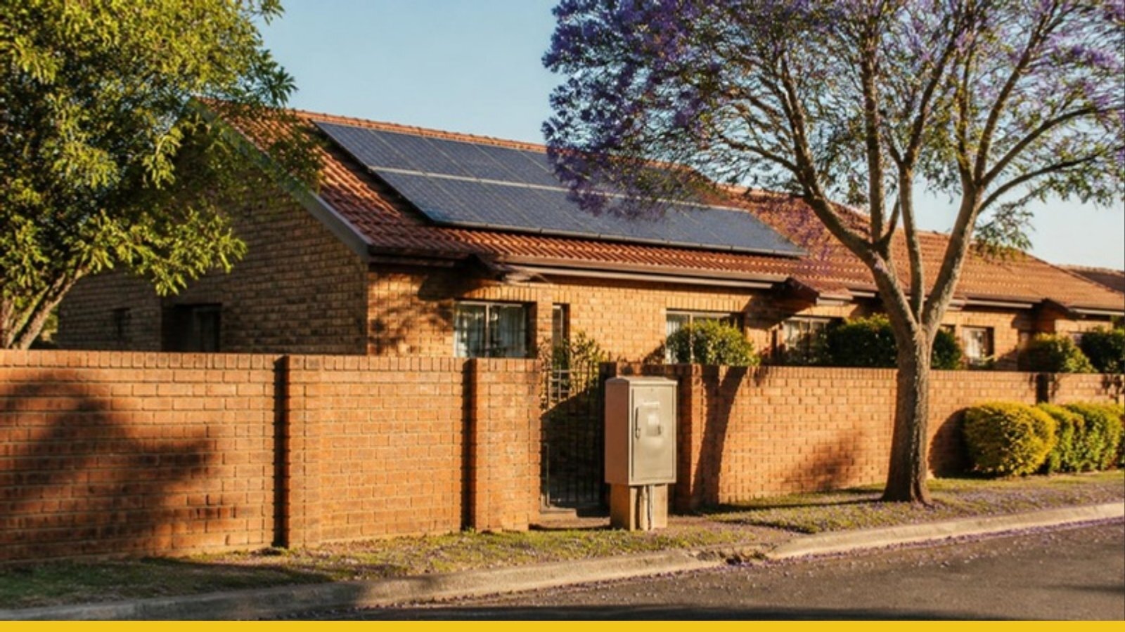 Johannesburg brick home with rooftop solar panels and a prepaid electricity meter box