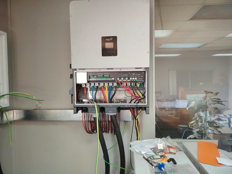 FoxESS hybrid inverter being wired by Madebere Electrical, with load, grid and battery cabling